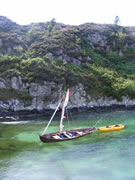 faering anchored, sial furled, in clear water